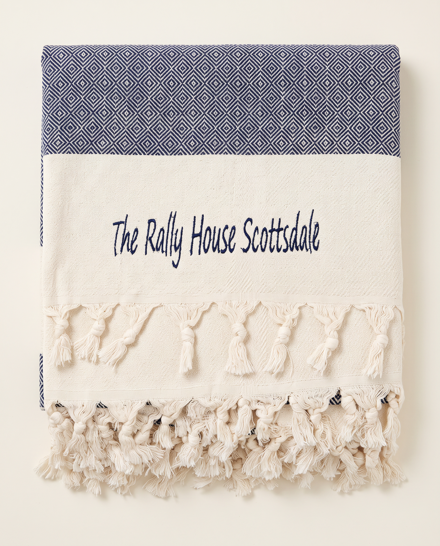 Rally House Scottsdale branded throw in a guest bedroom
