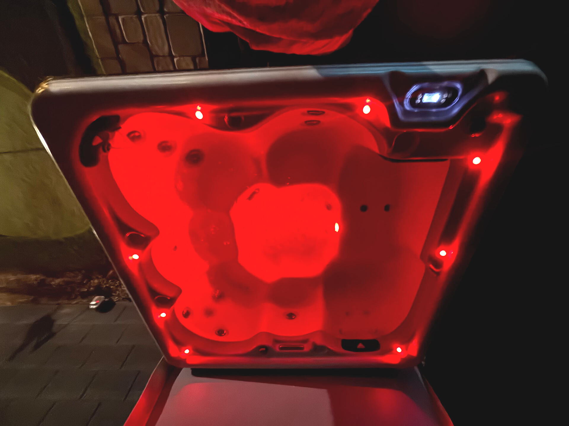 Private hot tub illuminated at night
